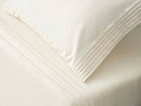 ivory pillowcase with luxury pleats detailing on it 