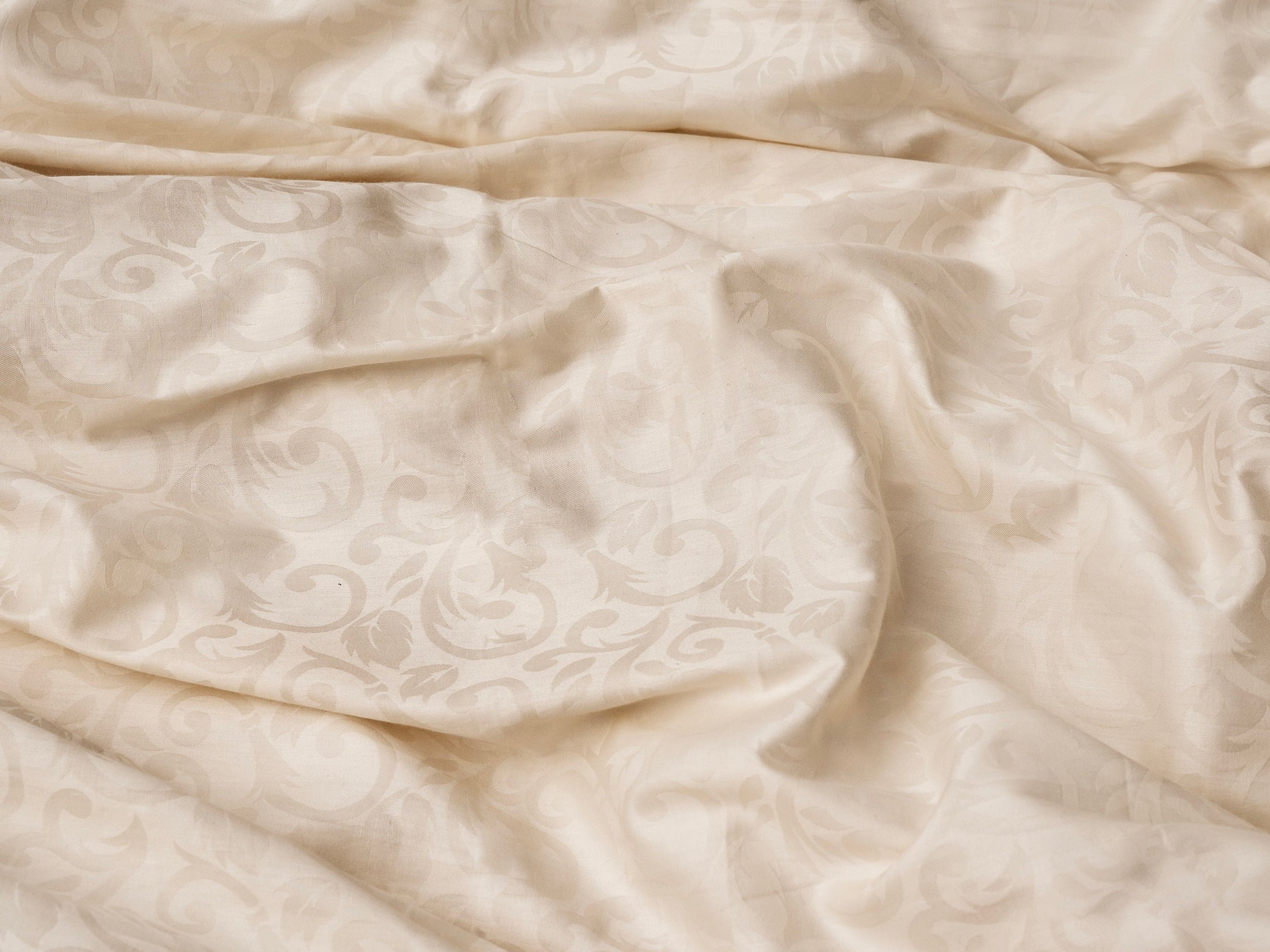 high thread count jacquard bedding with a floral pattern in ivory 