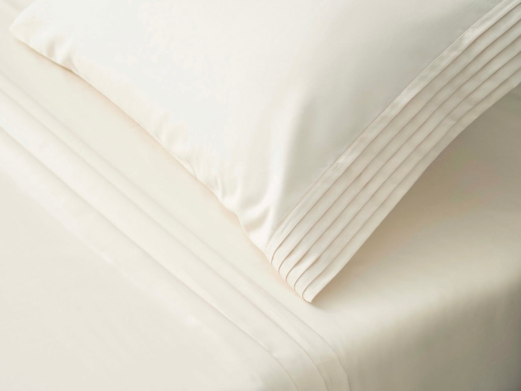 ivory pillowcase with luxury pleats detailing on it 