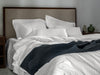 black organic cotton quilted bedspread with white bedding